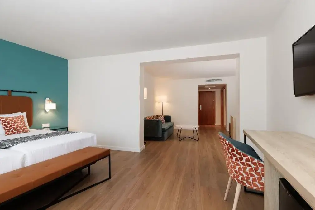 Spacious room with sleeping and sitting areas at Exe Vienna Hotel